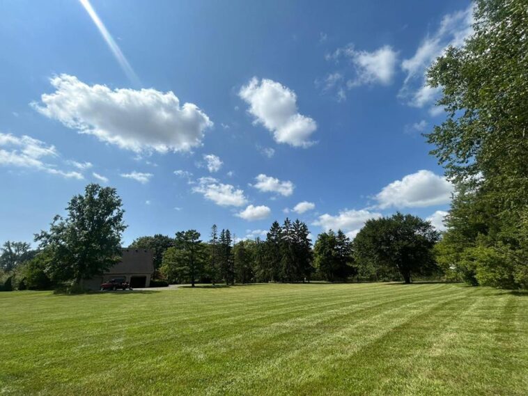 NLLC team member providing professional lawn care service in Niagara Falls, showcasing quality and attention to detail.