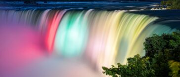 Mayor Robert Restaino presenting a ceremonial key to Ally Spongr during the announcement of Main Street redevelopment in Niagara Falls.