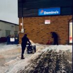 NLLC team clearing snow from a Domino’s Niagara driveway to ensure safe access for customers and deliveries.