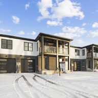 Professional snow removal service clearing a residential driveway in Niagara Falls during winter