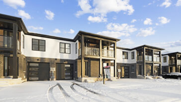 Professional snow removal service clearing a residential driveway in Niagara Falls during winter