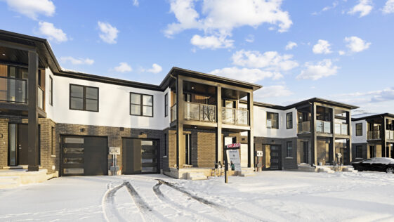 Professional snow removal service clearing a residential driveway in Niagara Falls during winter