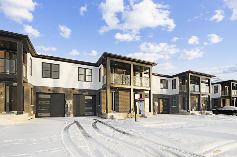 Professional snow removal service clearing a residential driveway in Niagara Falls during winter