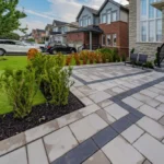 Backyard after stone tile interlocking installation for improved maintenance and curb appeal