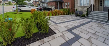 Backyard after stone tile interlocking installation for improved maintenance and curb appeal