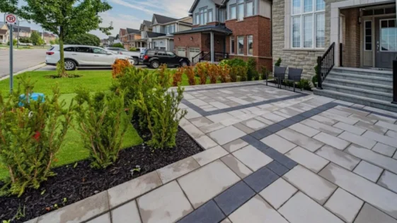 Backyard after stone tile interlocking installation for improved maintenance and curb appeal
