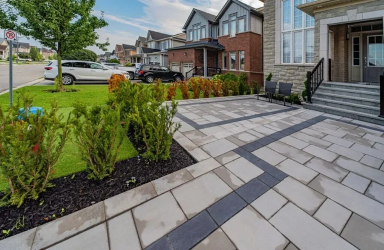 Backyard after stone tile interlocking installation for improved maintenance and curb appeal