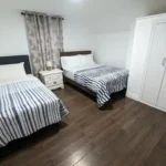 Student apartment living room in Niagara Falls featuring a modern furnished space by The Home Away From Home Developments Inc