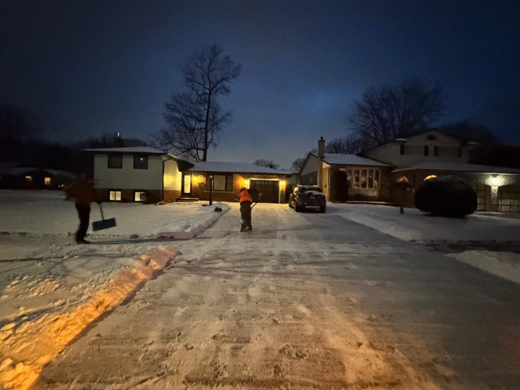 Snow-covered driveway and walkway in Niagara Falls, highlighting the importance of timely snow removal for safety and legal compliance.
