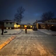 Snow-covered driveway and walkway in Niagara Falls, highlighting the importance of timely snow removal for safety and legal compliance.