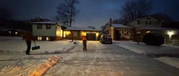Snow-covered driveway and walkway in Niagara Falls, highlighting the importance of timely snow removal for safety and legal compliance.