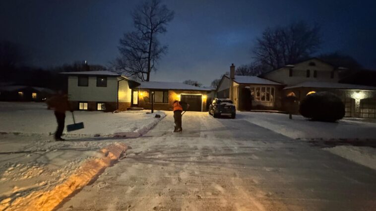 Snow-covered driveway and walkway in Niagara Falls, highlighting the importance of timely snow removal for safety and legal compliance.