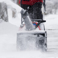 Snow removal in progress on a residential and commercial property, highlighting the difference between services and safety measures.